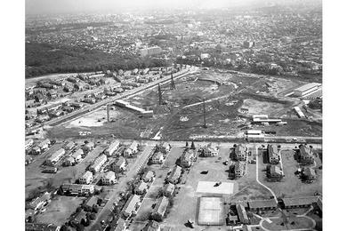 Olympic Stadium construction near Washington Heights Housing area.