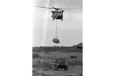Coming in with the helicopter onto Khe Sanh are mail, newspapers, and other small things.