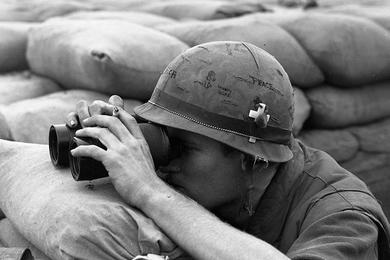 A Marine at Khe Sanh takes a closer look at the North Vietnamese troops harassing the base in recent months.