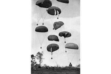 Supplies dropped out of an Air Force C-130 cargo plane pummel to the ground in the drop zone at Khe Sanh.
