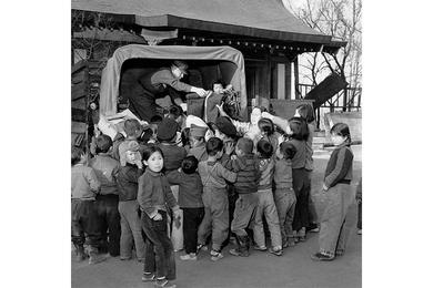 Blankets from baptists in the U.S. are distributed at Seoul Police and Soldiers orphanage to children in the institution by SFC John C. Wilson.