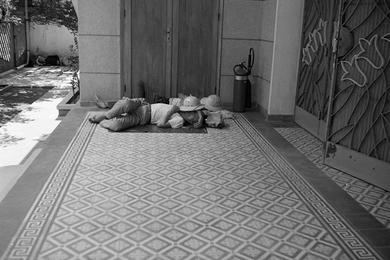 Unidentified Vietnamese find a spot to catch some zzzz's. Exact location unknown.