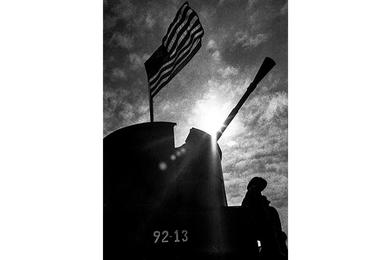 An armored troop carrier is silhouetted against the sun on the My Tho River, 65 miles from Saigon, where Americans from the 9th Infantry Division's 2nd Brigade Riverine Force and South Vietnamese from the 5th Vietnamese Marine Battalion were engaged in a day-long battle that ended with 235 Viet Cong reported killed.