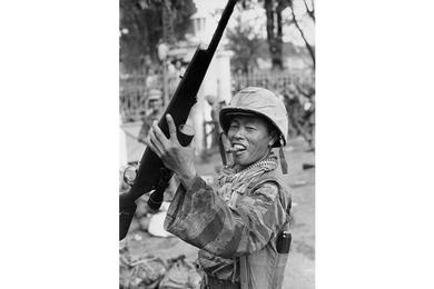 A Vietnam Marine holds a coup trophy, Nov. 1, 1963. Vietnam Marine celebrates on the streets of Saigon after the successful coup deposing president Ngo Dinh Diem November 1, 1963.
