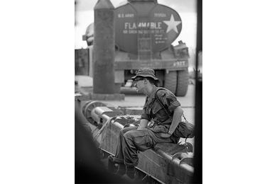 A photographer named Cullinan - first name unknown - sitting on the dock, talking to a crewmember of a flame boat.