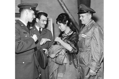 Getting Acquinted with Japanese movie star Reiko Dan at Toho movie studio on Pal Day Thursday are (left to right) SP4 John P. Campbell, T/Sgt. William Lambert Jr. and SP5 David G. Blangsted, all of whom worked in the movie industry before entering the service. Blangsted is from transportation office. 