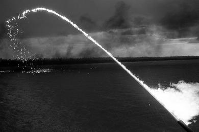 Zippo fires napalm as a fire boat does some target practice on My Tho river.