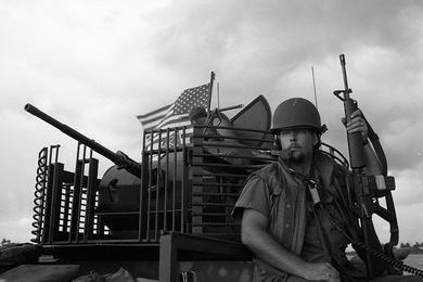 Radioman Donald Samply, RM3 (forefront) and gunner SN Stephen Artz look out over the My Tho river.