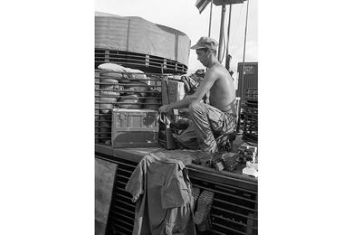 FN Gerald B. Reid tapes M-16 magazines to the machine gun. Reid is part of the crew of a U.S. Navy manning a flame boat on My Tho river.