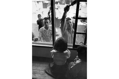 RUFF (LEFT) AND CHAPLAIN BIGGS PAINT WINDOW FRAMES: Orphans Sit Inside Watch Progress of Building Program. Lt. Col. Fred J. Ruff and Chaplain (Maj.) William H. Briggs paint the window frames of the Sungnam Orphanage in Seoul.