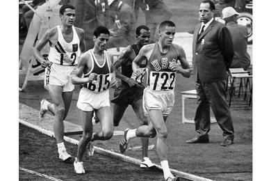 Billy Mills leads the pack at about 9,000 meter mark in the 10,000-meter Olympic run at National Stadium Wednesday.