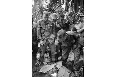 Marines lite a fire in the morning to warm themselves after a night of rain.