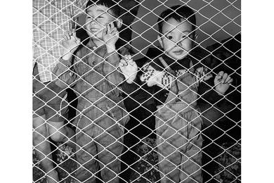 These two boys were among the curious watchers outside the fence during the dedication ceremony.