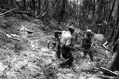 Members of Mike Co. move through rough jungle terrain on the way to Hill 484.