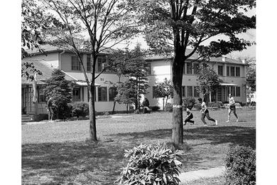 Athletes use lawns of former housing units for practice areas.