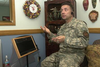 A chaplain demonstrates a therapy board.