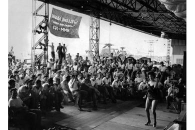 American USO trooper Bunita Jeane dances for members