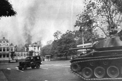 A tank can be seen moving toward the Presidential Palace in Saigon