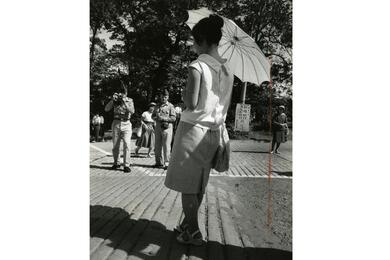 a Japanese woman holding up her parasol. 