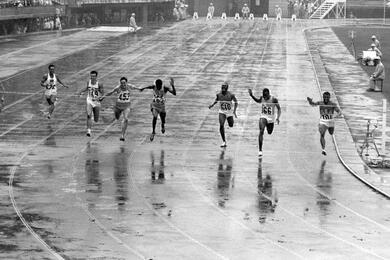 U.S. team member and Army Sgt. Mel Pender (right) wins his qualifying heat in the men’s 100 meters.