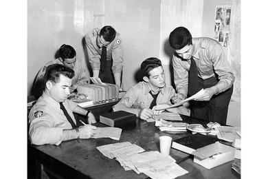 A young, comparatively lean Ricketts (left) slashes "copy" the way he was to slash movies and stageshows. He was a proofreader in young, lean days.