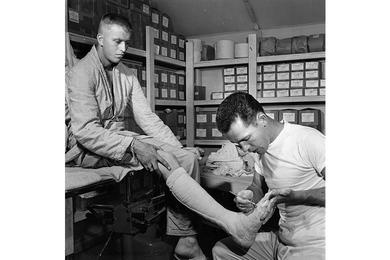 SP1 Paul W. Sebesky prepares leg cast; The 121st Evacuation Hospital in South Korea – commanded by Maj. Thomas G. Nelson – admits nearly 700 patients a month through its doors for resident treatment.