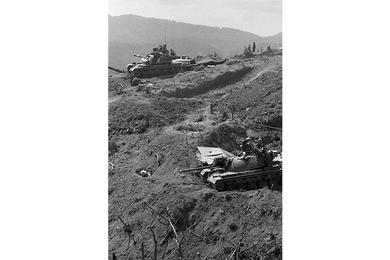 Two Patton tanks from the 3rd Battalion, 5th Mechanized Infantry Division have taken up position overlooking the Laotian-Vietnamese border atop Hill 937 of Dong Ap Bia - better known to Americans as Hamburger Hill.
