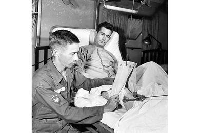 SP2 Wilford Shields checks Russell Traction on patient. The 121st Evacuation Hospital in South Korea – commanded by Maj. Thomas G. Nelson – admits nearly 700 patients a month through its doors for resident treatment.