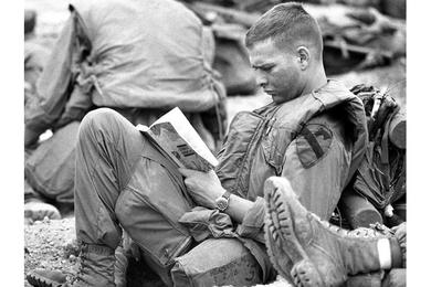 A soldier from 2nd Battalion, 12th Cavalry, 1st Cavalry Division reads a book as he waits to be airlifted to Landing Zone Timothy during Operation Pegasus, a 20,000-man effort to relieve Marines at the beleaguered combat base at Khe Sanh.