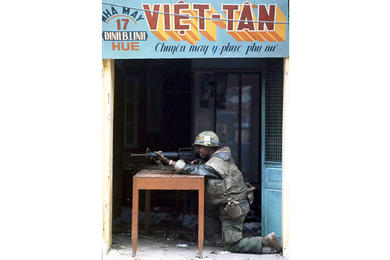 A U.S. Marine takes aim at the enemy from a storefront during the fierce, monthlong battle for Hue, the onetime seat of the Nguyen dynasty and pre-World War II capital of Vietnam.