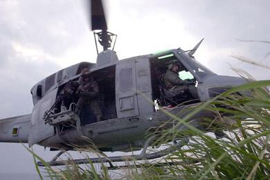 Pilots and crews of a UH-1N Huey lift off after inserting an infantry team.