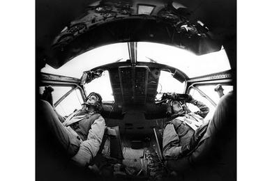 In an unusual view through a fisheye lens, Capt. Kenneth Rubin, left, and Capt. George Thurmond of the 334th Armed Helicopter Company at Bien Hoa hunt for Viet Cong.