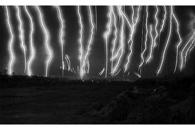 Illumination rounds fill the sky over Landing Zone Ross, a staging area for U.S. operations in South Vietnam's Que Son Valley.