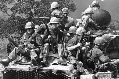 U.S. infantrymen ride a tank into action north of Chu Lai.