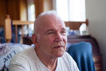 Marine veteran Joe Scholle tells of his days serving as a UH-34D helicopter pilot in Vietnam as he clicks through a photo slide show at his home in Severna Park, Md., on Sept. 30, 2014