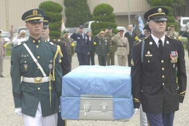 The remains of a U.S. soldier are carried to a waiting hearse Thursday on Knight Field at Yongsan Garrison.