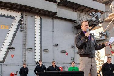 In a Dec. 15, 2019 photo, Capt. Brett Crozier, commanding officer of the aircraft carrier USS Theodore Roosevelt, gives remarks during an all-hands call on the ship's flight deck.