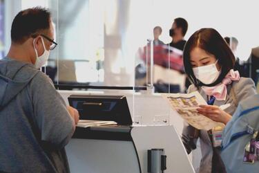 An airline agent assists a traveler at Haneda International Airport, Japan, on Nov. 10, 2021. 