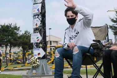 Humphreys High School senior Matthew Macy waves to his supporters during a reverse parade for soon-to-be graduates at Camp Humphreys, South Korea, Thursday, May 27, 2021.