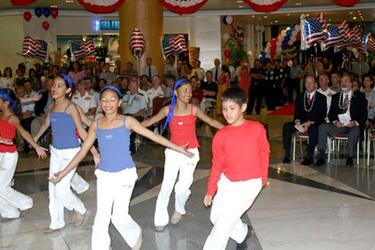 Members of local Guam dance troupe SKIP Entertainment perform during the opening ceremony of the Guam USO location in the Royal Orchid Hotel in Tumon, Guam.