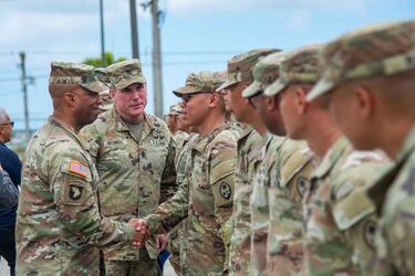 The head of U.S. Army Pacific, Gen. Ronald Clark, shakes the hand of a soldier.