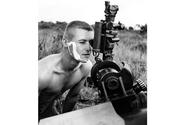 South Vietnam, July, 1965: A fire mission caught Sgt. Homer Charnock of Bravo Battery, 319th Artillery, in the middle of shaving.