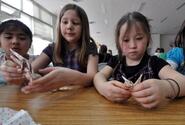 Third-graders from Sollars Elementary School at Misawa Air Base, Japan, work together April 8 to build origami cranes.