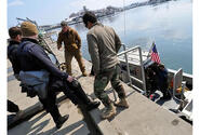 U.S. Navy divers discuss how to best survey the Hachinohe City port on Friday.