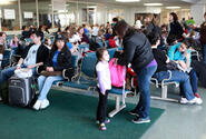 U.S. military family members wait to board a flight from Yokota Air Base, Japan, to Seattle, on Saturday.