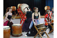 Kazuko Igarashi, center, leads the Dragon-Eagle Taiko drum team through a performance at Misawa Air Base, Japan, on Saturday.