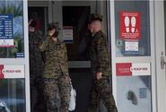 Marines enter and exit an exchange store at Camp Hansen, Okinawa, Dec. 20, 2021. 