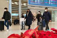 Airplane passengers exit an arrival gate wearing masks at Incheon International Airport, South Korea, Monday, Feb. 3, 2020.