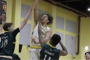Yokota's Connor Rowan goes up for a basket Thursday while defended by Robert D. Edgren's Shamar Parnell, right, and Alec Struve. Edgren won 47-45 in the last game of the season for both teams as DODEA-Pacific and military officials decided to cancel the Far East boys tournament at Camp Humphreys, South Korea, due to concerns of the spread of the coronavirus.