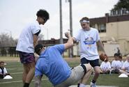 Atlanta Falcons defensive end Morgan Fox is helped to his feet during a youth football camp.